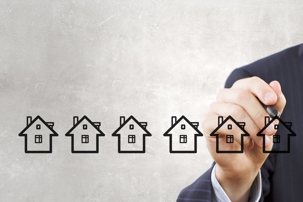 businessman-drawing-houses