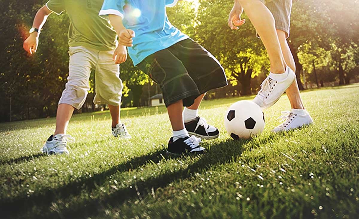 Little-Boy-Playing-Soccer-With-His-Father-Concept