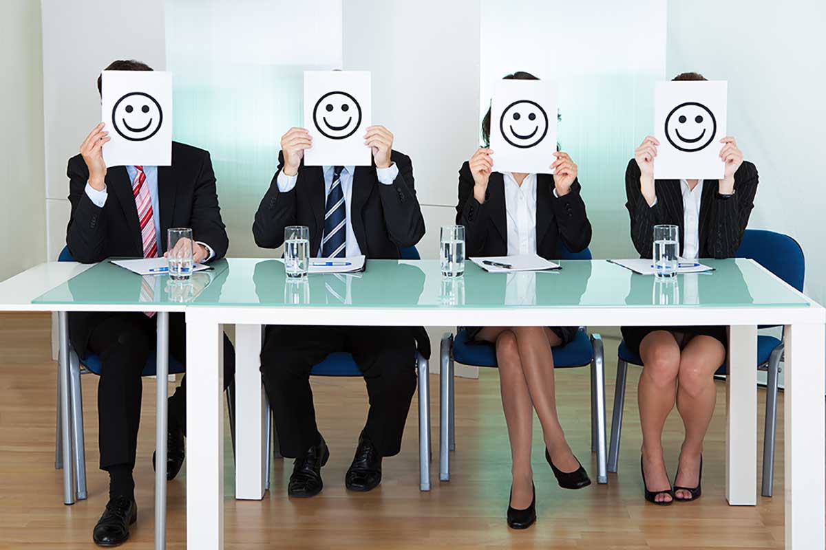 Row of business people with smiley faces