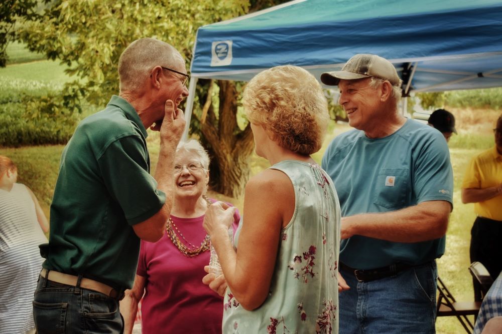 Group of older people talking outdoors