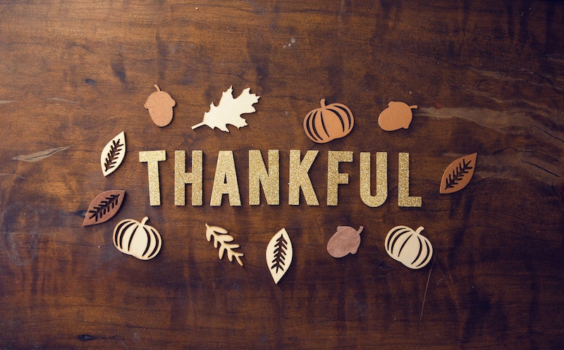 the word thankful surrounded by symbols of fall