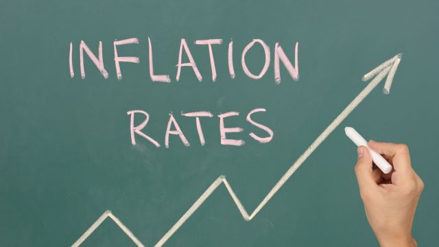 the words "inflation rates" written on chalk board